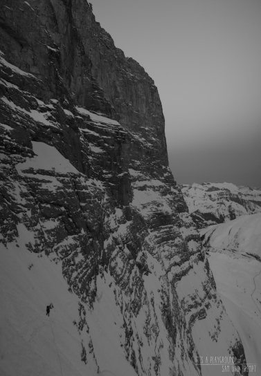 Maxime climbing on the lower part of Eiger's North Face. Stollenloch a bit lower in the back