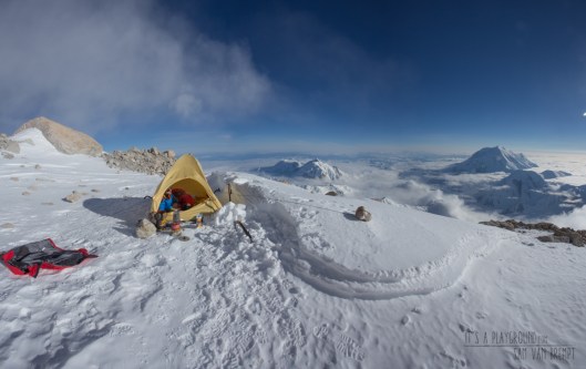 Maxime resting out at 17000ft on Denali's West Rib. Mt Hunter and Foraker in the back