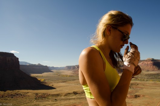 Molly taping up with to get going. Baffling desert scenery in the back.